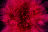 Abstract image of red coloured particles exploding from a centre point.