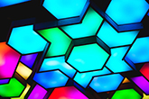 Abstract hexagon images backed by blue and turquoise lights.