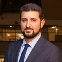 A man in business attire (Malek Haddad)